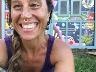 Sarah Stewart standing in front of one of her botanical murals